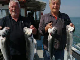 Two anglers holding up Bass