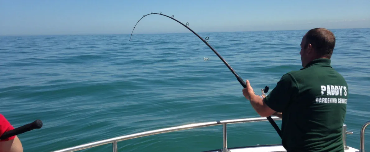 An angler with rod bent into a fish