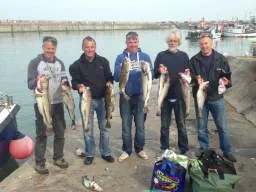 Several Anglers holding up part of days catch